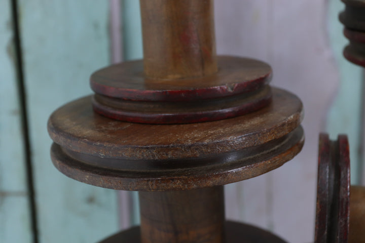 Vintage wooden spinning bobbins with painted details