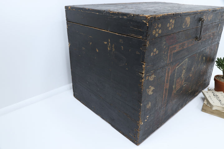 Decorative wooden box with intricate carvings and a metallic clasp.