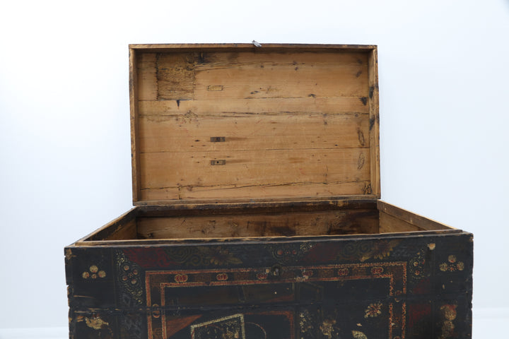 Decorative wooden box with intricate carvings and a metallic clasp.